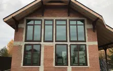 Великі вікна Aluplast у заміському будинку — енергоефективне скління з ламінуванням «горіх».
